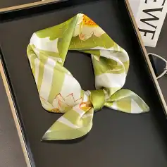 Versatile floral silk scarf with bright green, white, and orange accents, ideal for stylish women and trendy outfits.