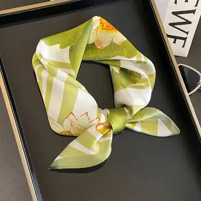 Versatile floral silk scarf with bright green, white, and orange accents, ideal for stylish women and trendy outfits.