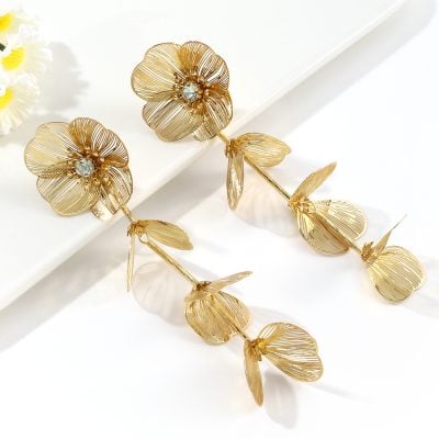 Luxury gold flower earrings featuring intricate petal designs and sparkling crystal accents, perfect for stylish accessorizing.