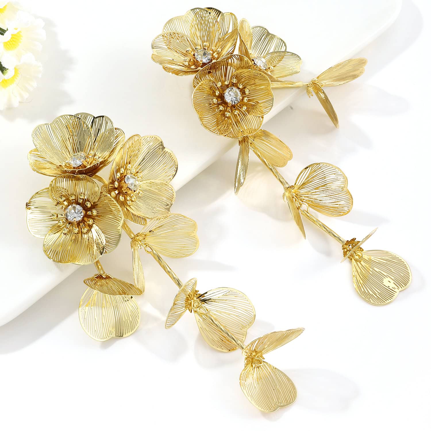 Stunning gold flower jewelry earrings with crystal center accents, perfect for stylish women seeking luxurious accessories. Ideal for special occasions and elegant fashion statements.