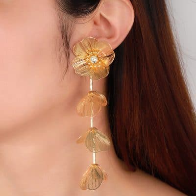 Stunning gold floral earring featuring layered petal design, gemstone center, and cascading leaf accents. Perfect for adding a glamorous touch to any outfit.