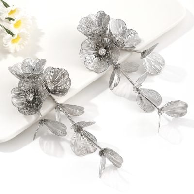 Stunning silver floral hair accessories with intricate petal details and crystal embellishments, perfect for special occasions or everyday fashion statements.