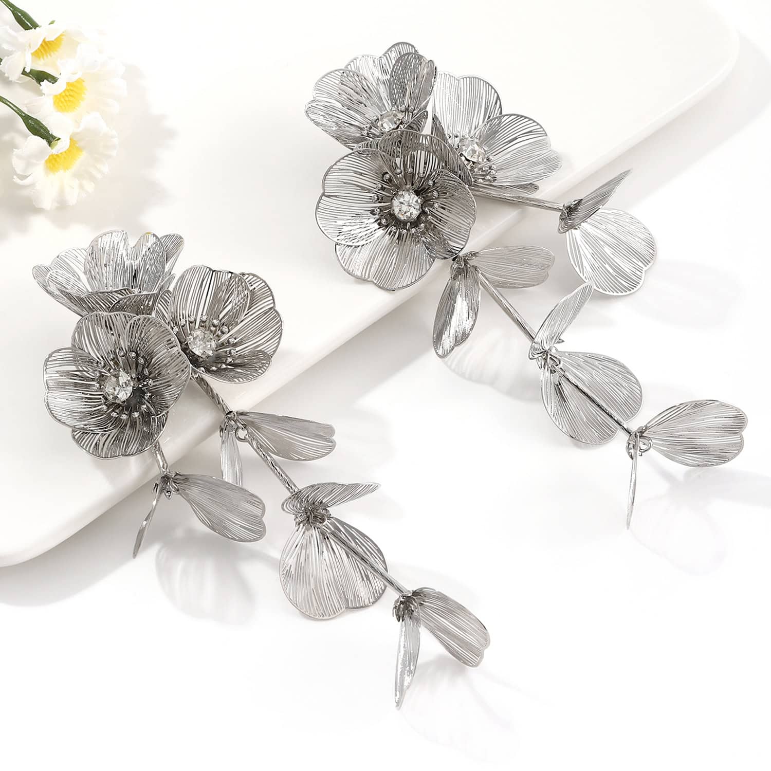 Stunning silver floral hair accessories with intricate petal details and crystal embellishments, perfect for special occasions or everyday fashion statements.