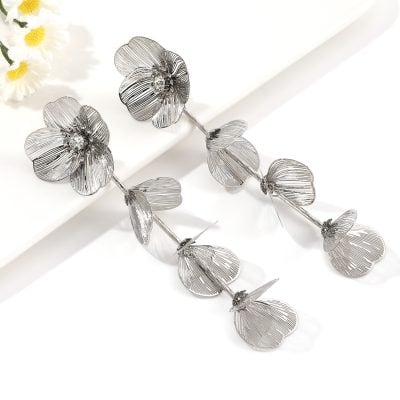 Sterling silver floral earrings with intricate petal design and sparkling rhinestone accents, perfect for stylish accessories and jewelry lovers.