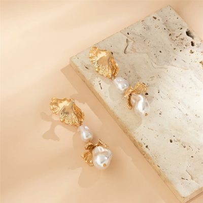 Luxurious gold and pearl drop earrings for sophisticated style and elegant accessories. Perfect for fashion-forward women seeking unique jewelry pieces.