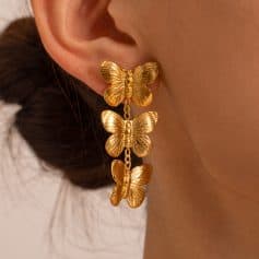 Stylish butterfly gold earrings with three hanging butterflies, perfect for elegant and trendy jewelry looks.