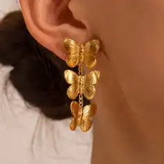 Gold butterfly earrings featuring a cascading design, perfect for adding sparkle and style to any outfit. Made with high-quality jewelry materials, these earrings are ideal for fashion-forward individuals.
