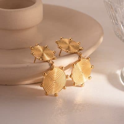 Luxurious gold spiral earrings with intricate swirling design, perfect for enhancing your style and making a statement in any outfit. Ideal for fashion-forward individuals.