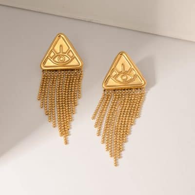 Gold evil eye triangle earrings with hanging fringe design for women, trendy statement jewelry. Perfect for enhancing your fashion style and accessorizing with unique, eye-catching pieces.