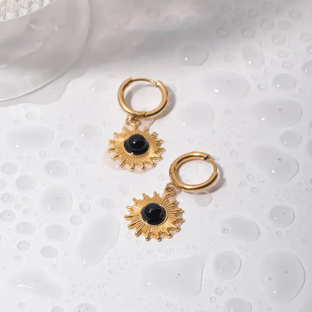 Stylish gold hoop earrings featuring a black gem accent, perfect for women seeking trendy jewelry. Ideal for everyday wear or special occasions, enhancing any outfit with a touch of luxury.