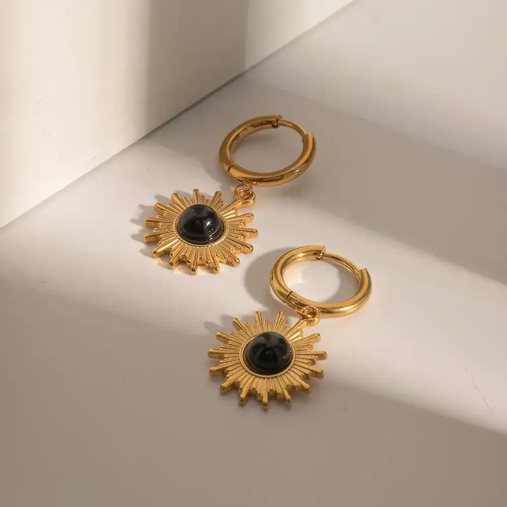 Elegant gold sunburst earrings featuring a central black stone, perfect for stylish accessories. Shop high-quality jewelry at Monalisa Store for a luxurious look.
