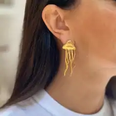 Gold jellyfish earrings with flowing tentacles, stylish accessories for women. Unique jewelry design perfect for fashionable outfits and special occasions.