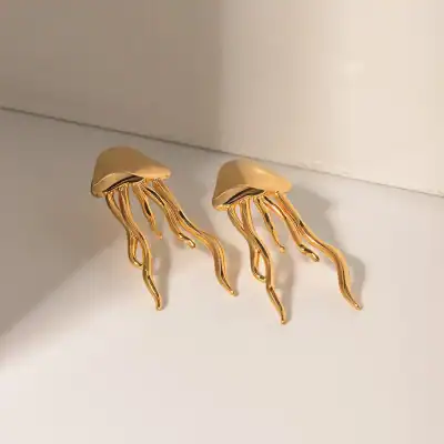 Elegant gold and cream jewelry, jellyfish-inspired earrings with flowing tentacle design, perfect for stylish accessories.