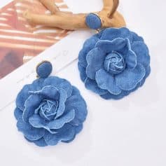 Elegant blue denim flower accessories, perfect for fashion-forward women seeking stylish jewelry and handbag options.