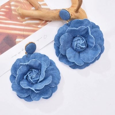Elegant blue denim flower accessories, perfect for fashion-forward women seeking stylish jewelry and handbag options.