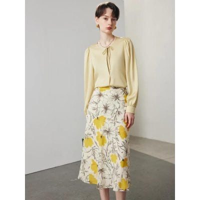 Stylish yellow women's blouse paired with a floral skirt, perfect for casual or semi-formal occasions at Monalisa Store. Discover trendy women's clothing and accessories.