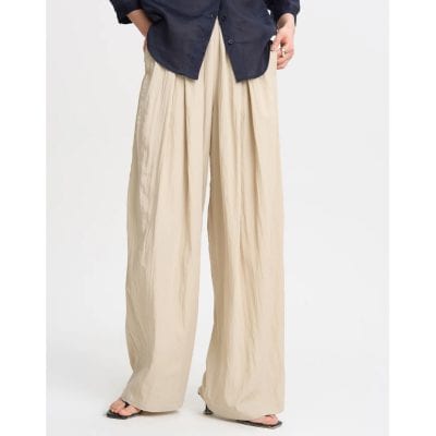 Comfortable beige wide leg trousers for women, perfect for casual and chic outfits, made from lightweight fabric for all-day wear.