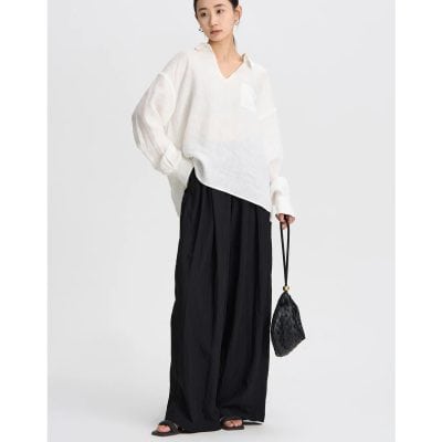Elegant casual Monalisa fashion with a white loose top and stylish black wide-leg pants.