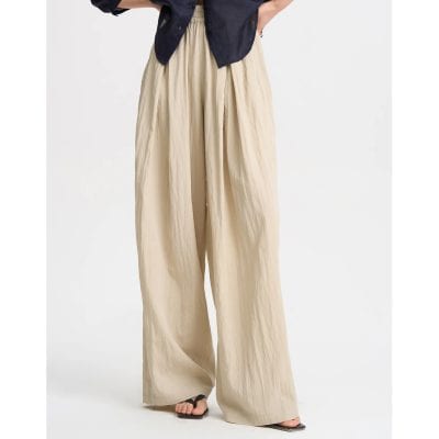Elegant beige wide-leg pants for women with comfortable fit, perfect for casual and formal occasions. Made from lightweight, breathable fabric.