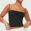 Elegant black tank top with thin adjustable straps and ruched detail at the bust, perfect for casual or dressy occasions.