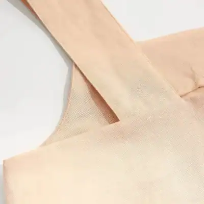 Close-up of a soft pink silk blouse with elegant texture, perfect for stylish women seeking premium fashion choices.