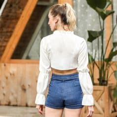 Elegant white cropped blouse with billowing bell sleeves, perfect for trendy casual or party wear. Made from comfortable, high-quality fabric for a chic, modern look.