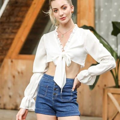 Elegant white crop top with ruffle details and tie-front design, perfect for fashion-forward women. Made from breathable fabric, ideal for casual outings and summer wear.