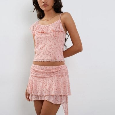 Pink floral summer outfit for women with ruffle accents and layered skirt, ideal for beach, casual or vacation wear.