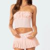 High-quality pink satin lingerie crop top with ruffle details and matching pleated mini skirt, perfect for stylish and comfortable wear.