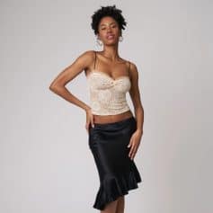 Glamorous women's lace camisole with delicate floral patterns, adjustable spaghetti straps, and a stylish ruffle-hem satin skirt for trendy, upscale fashion. Perfect for date nights or special occasions.