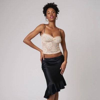 Glamorous women's lace camisole with delicate floral patterns, adjustable spaghetti straps, and a stylish ruffle-hem satin skirt for trendy, upscale fashion. Perfect for date nights or special occasions.