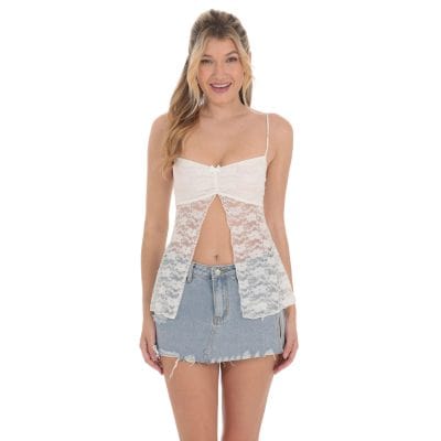 Delicate white lace top paired with a distressed denim mini skirt, perfect for fashion-forward, stylish women looking for trendy and elegant summer clothing options.
