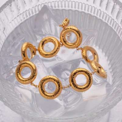 Elegant gold bracelet with hollow circular links, perfect for high-end fashion and accessories. Crafted with precision, ideal for stylish occasions and gifting.