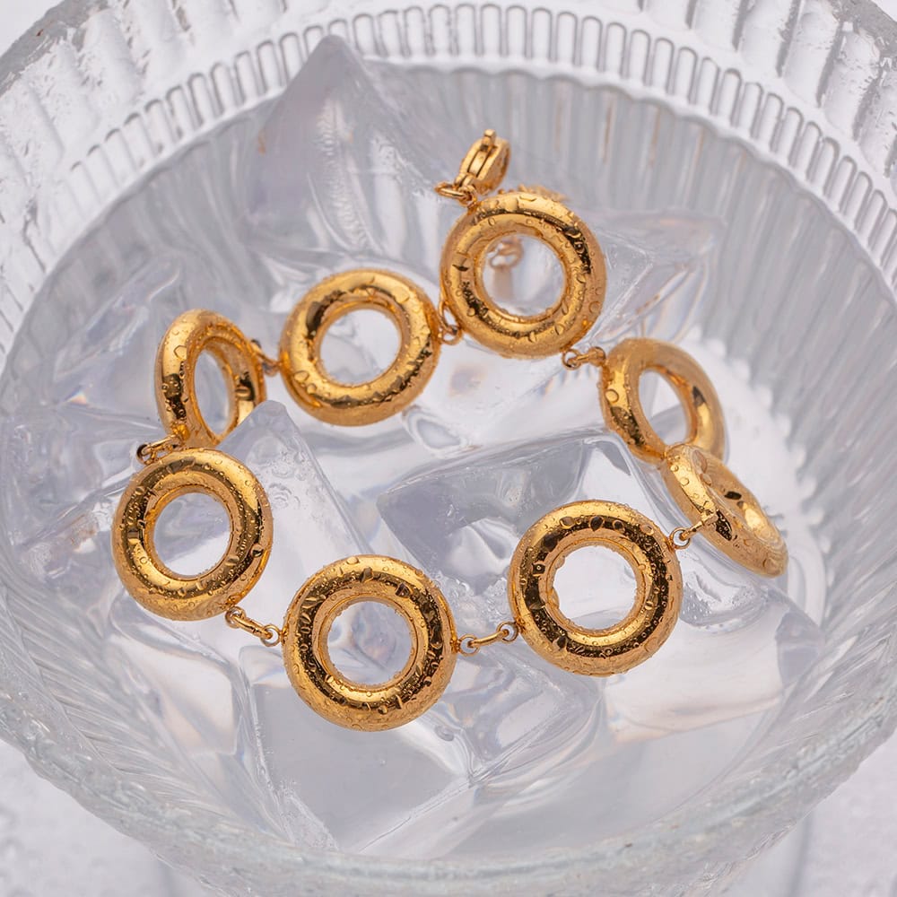 Elegant gold bracelet with hollow circular links, perfect for high-end fashion and accessories. Crafted with precision, ideal for stylish occasions and gifting.