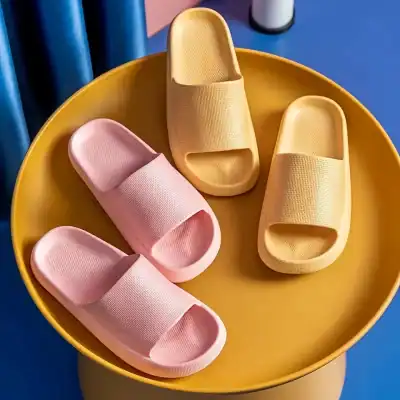 Comfortable pink and yellow slippers for home and casual wear.