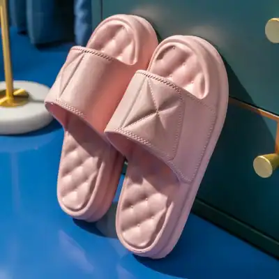 Comfortable pink slippers with quilted insoles and padded straps for everyday wear and relaxation.