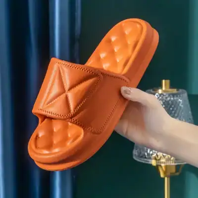 Comfortable orange slippers with cushioned insole, perfect for home use or spa. Designed for style and relaxation, available at Monalisa Medical Store, combining comfort and elegance.