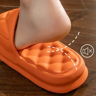 Comfortable orange slippers with soft soles and cushioned insoles, perfect for indoor use. Designed for relaxation and foot support, ideal for everyday comfort.