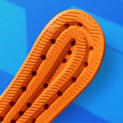 Comfortable orange orthopedic insoles with arch support, designed to improve foot health and reduce pain. Crafted for durability and support.