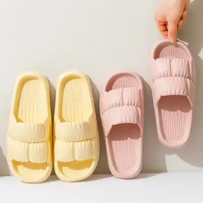 Soft yellow and pink slippers for women or men, perfect for home relaxation or spa use, offering comfort and style. Ideal for bedrooms, bathrooms, or leisure wear.