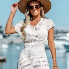 Stylish wide-brim sunhat with dark sunglasses for a fashionable summer look at the marina or beach.