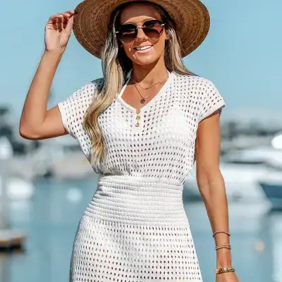 Stylish wide-brim sunhat with dark sunglasses for a fashionable summer look at the marina or beach.