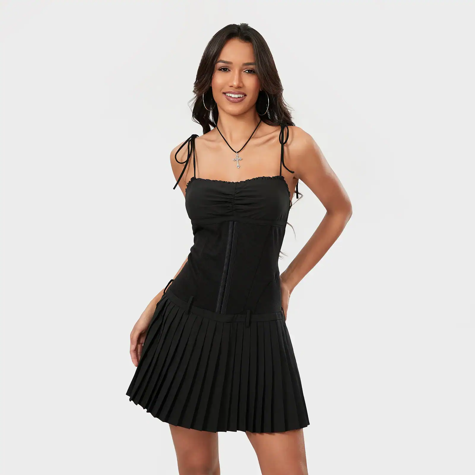 Stylish black mini dress with pleated skirt and adjustable shoulder ties, perfect for fashion-forward women and special occasions.