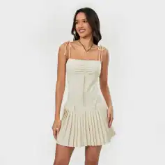 Stylish beige women's dress with adjustable ties, square neckline, and pleated skirt, perfect for casual wear, parties, or special occasions.