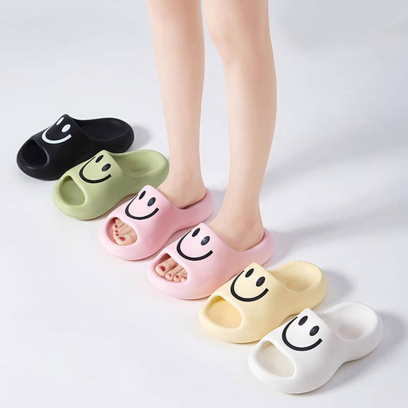 Cute smiley face slippers in multiple colors, perfect for comfortable indoor wear, stylish loungewear, and casual home footwear for women and men.