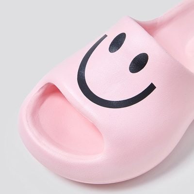 Comfortable pink slide slippers with a smiling face design, perfect for casual wear and cozy home comfort. Durable, lightweight, and stylish for men, women, and kids.