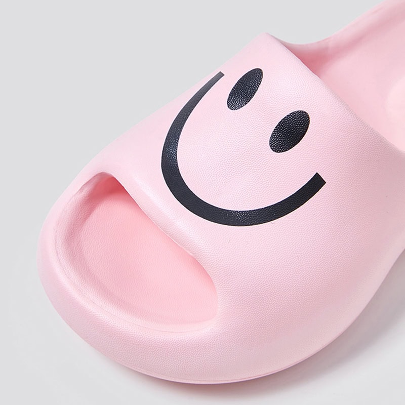 Comfortable pink slide slippers with a smiling face design, perfect for casual wear and cozy home comfort. Durable, lightweight, and stylish for men, women, and kids.