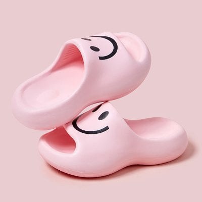 Pink slippers with smiling face design, perfect for comfortable home wear. Trendy and cute footwear ideal for women seeking stylish slippers from Monalisa Medical Store.