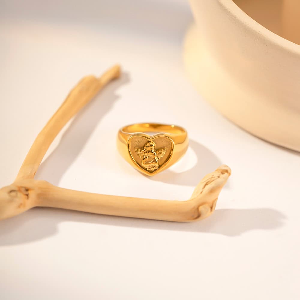 Elegant gold ring featuring a detailed angel motif, perfect for stylish accessories or special occasions. Crafted for durability and timeless elegance.