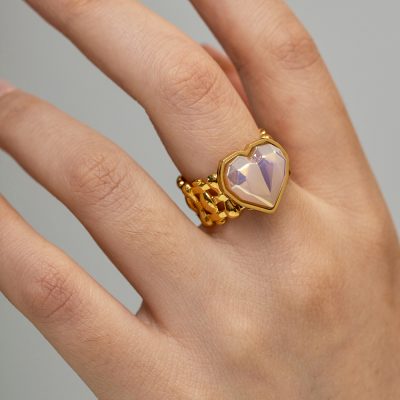 Elegant gold ring featuring a pink heart-shaped gemstone, perfect for women's jewelry collections and special occasions.